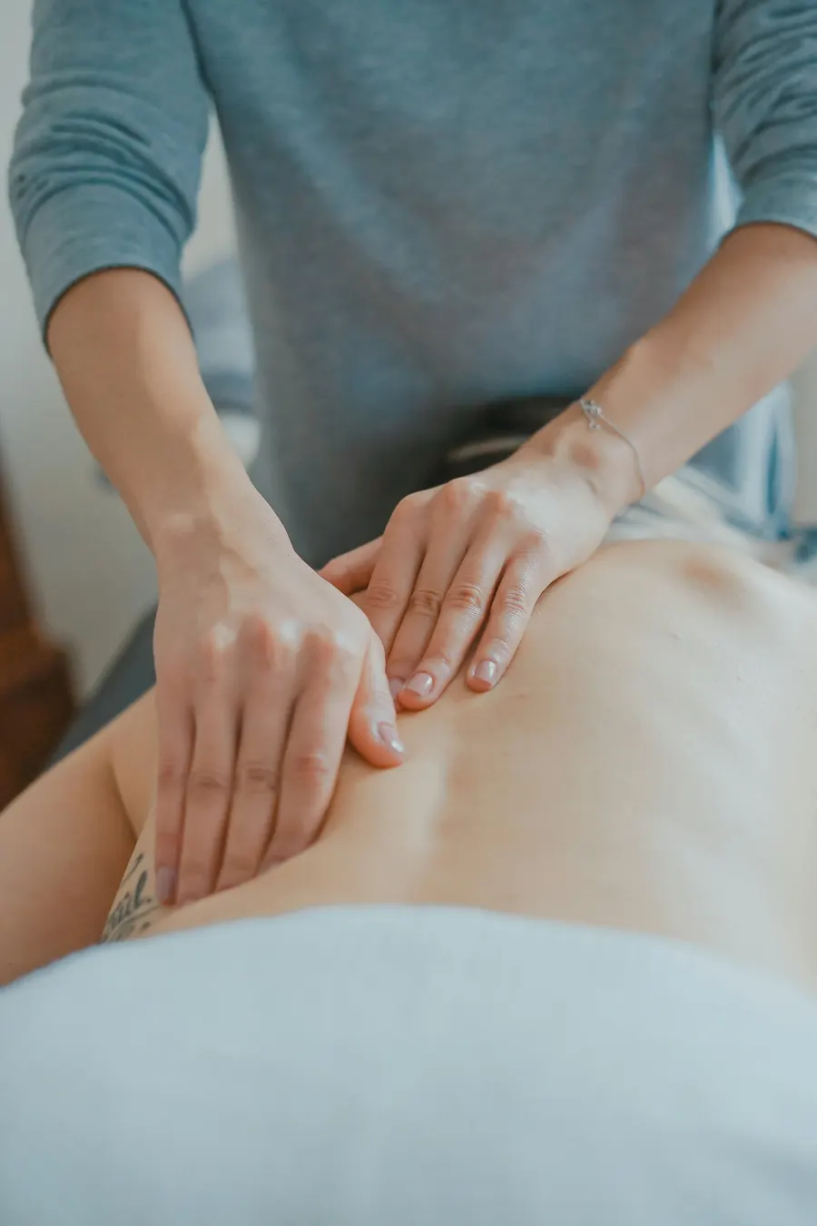 A complementary medicine practice website showing therapies, practitioner profiles and an online booking calendar