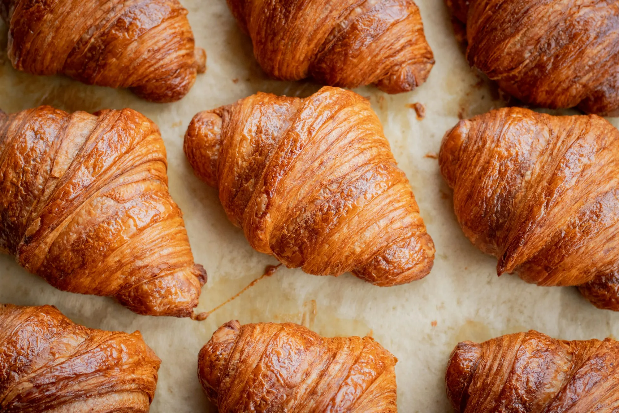 A tray of golden croissants and viennoiserie