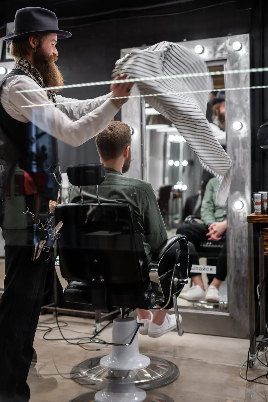 A barber refining the beard lines