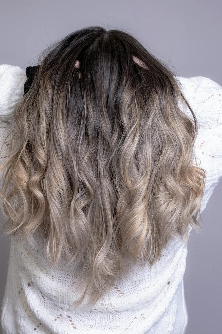 Blonde balayage on long hair seen from behind