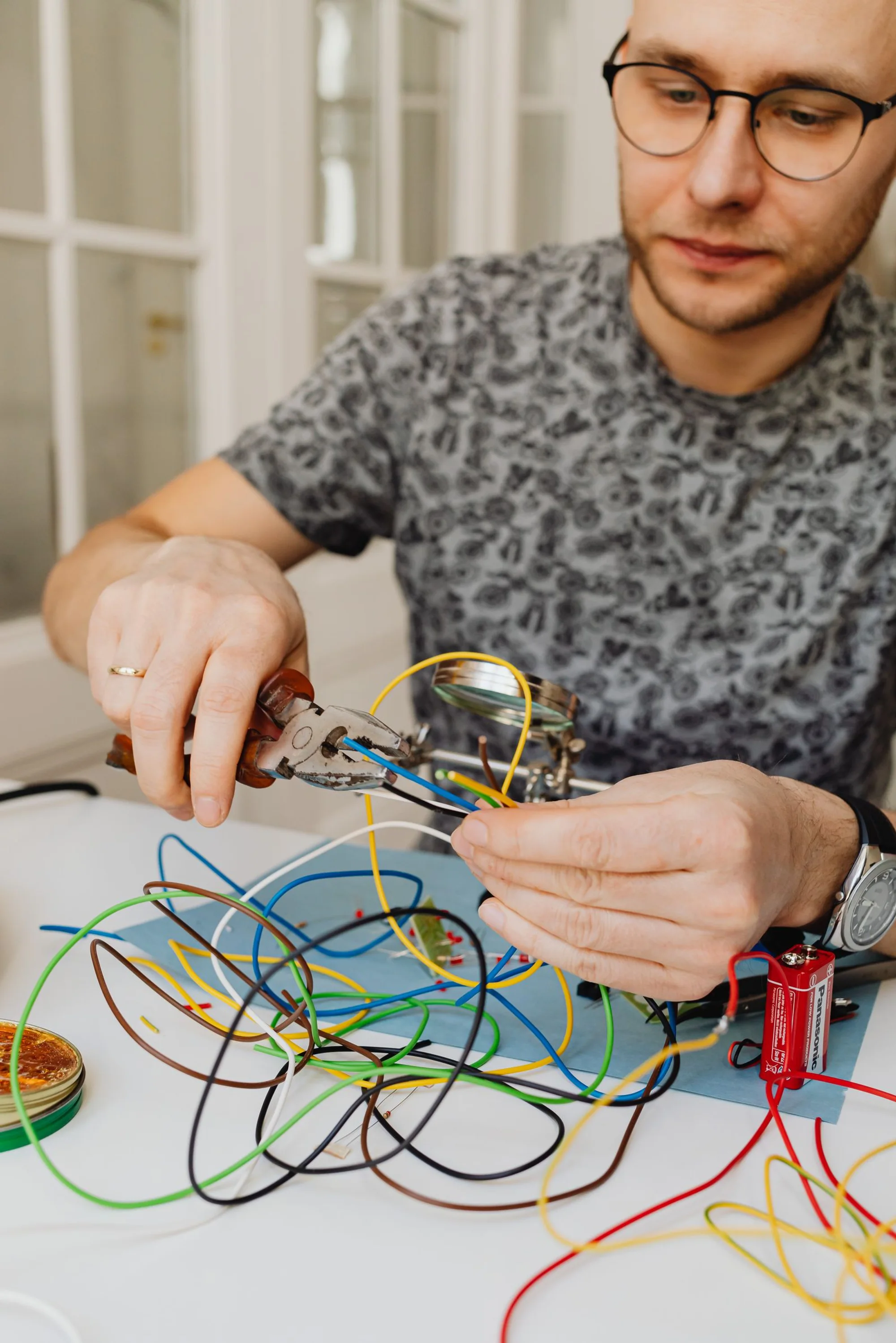 A smiling electrician working on a distribution board