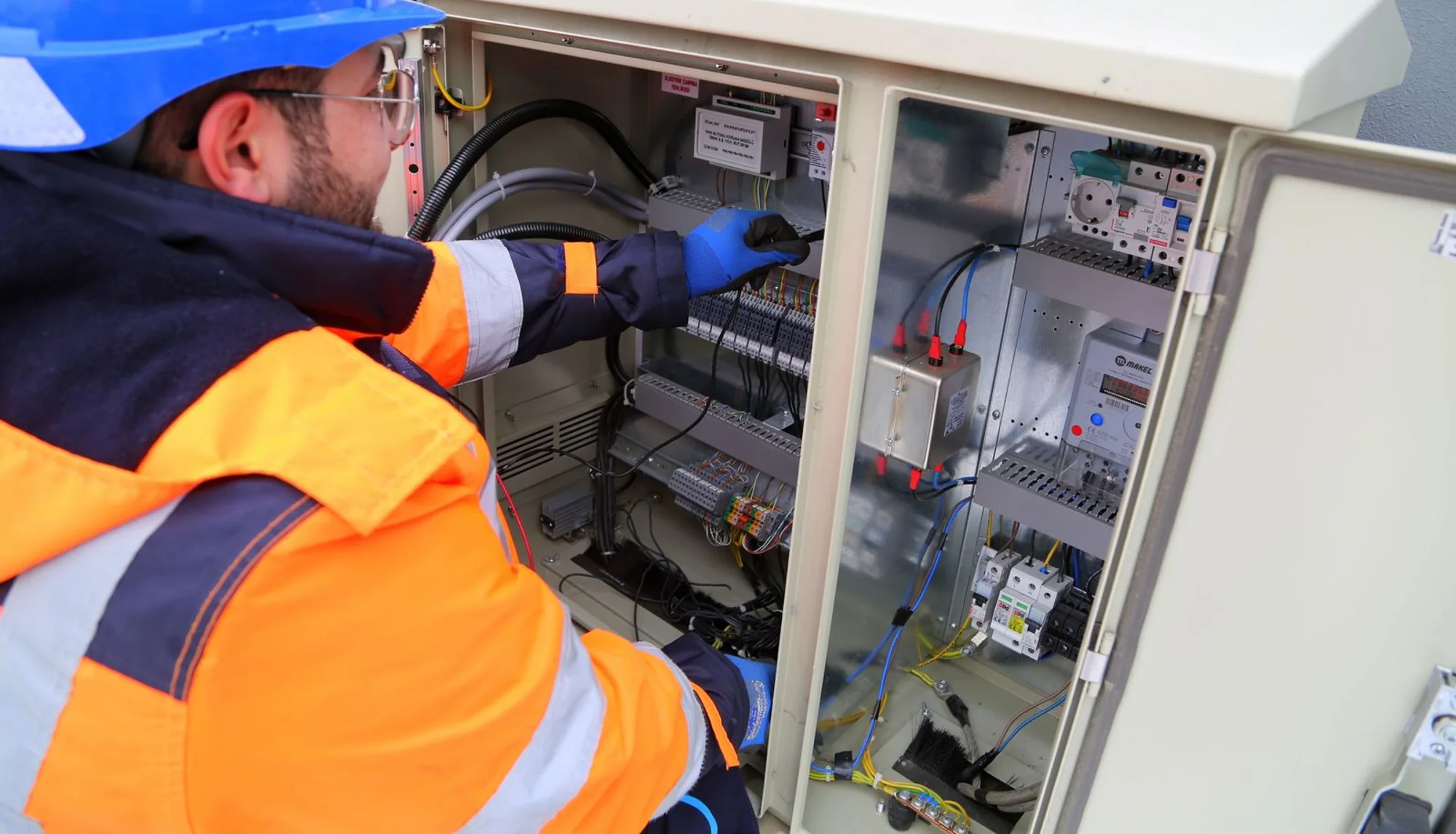 An electrician working on a system during an emergency callout
