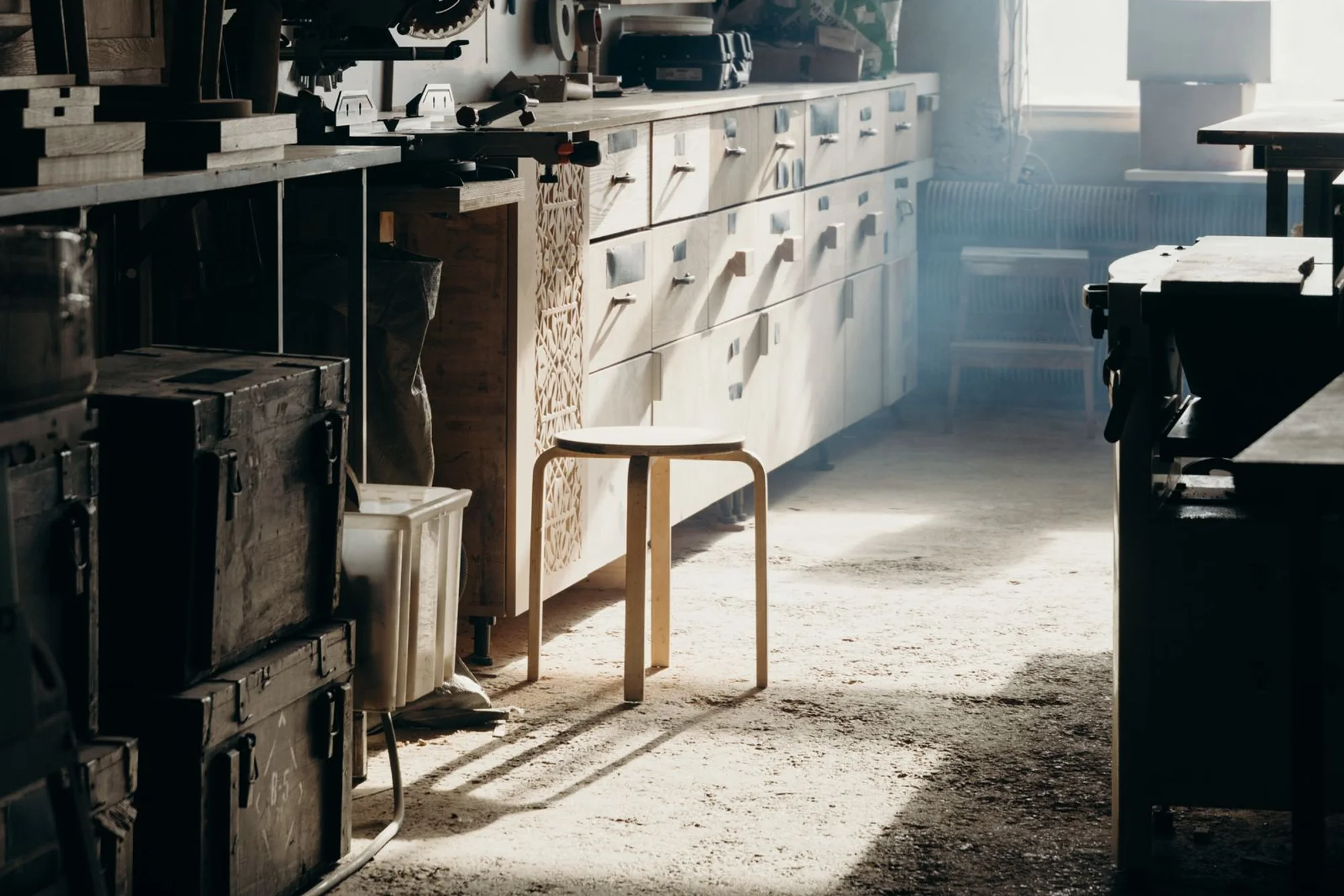 Interior of the workshop with joiner's bench, machines and wood shelves