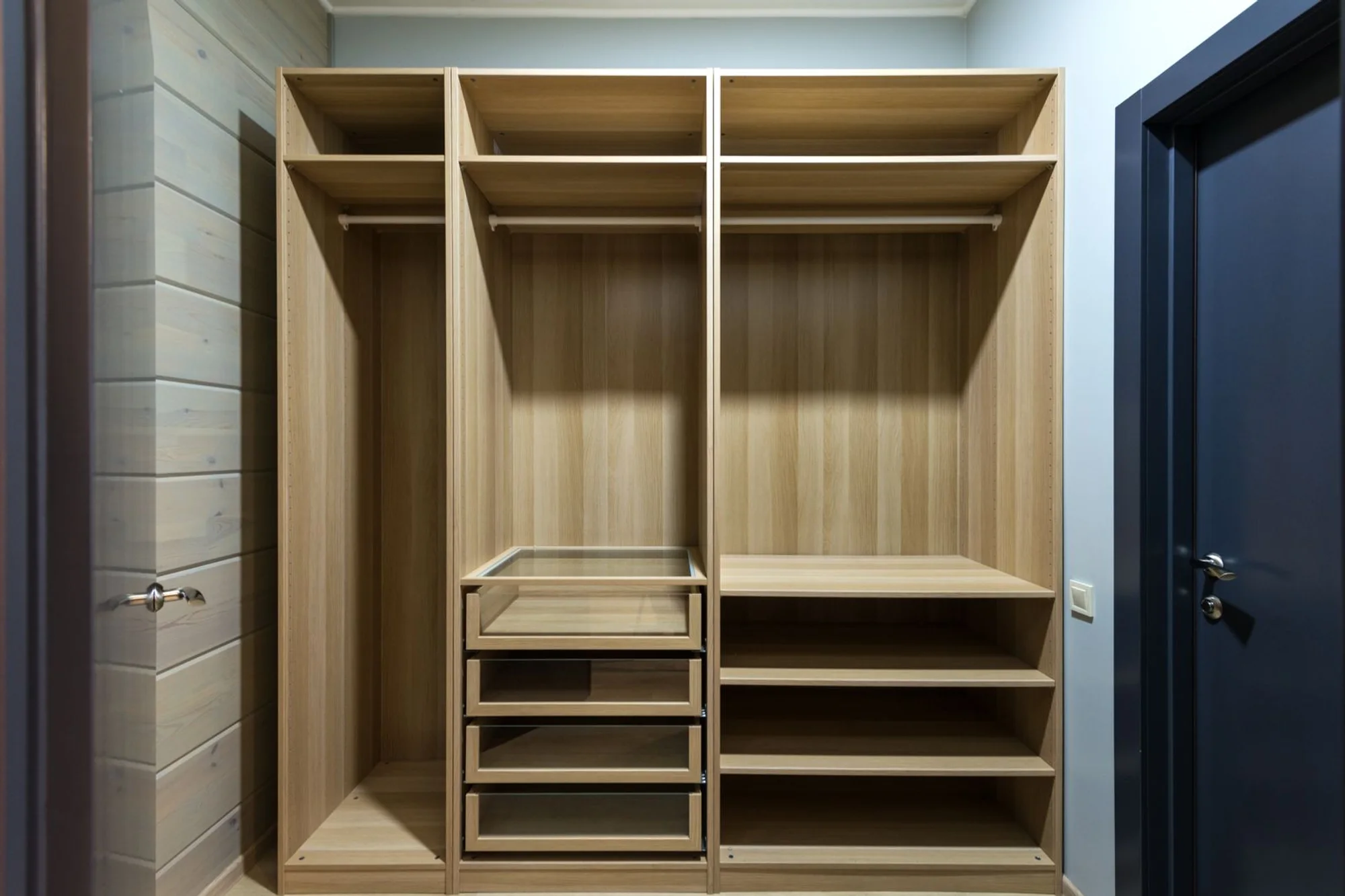 A bespoke oak walk-in wardrobe with integrated lighting