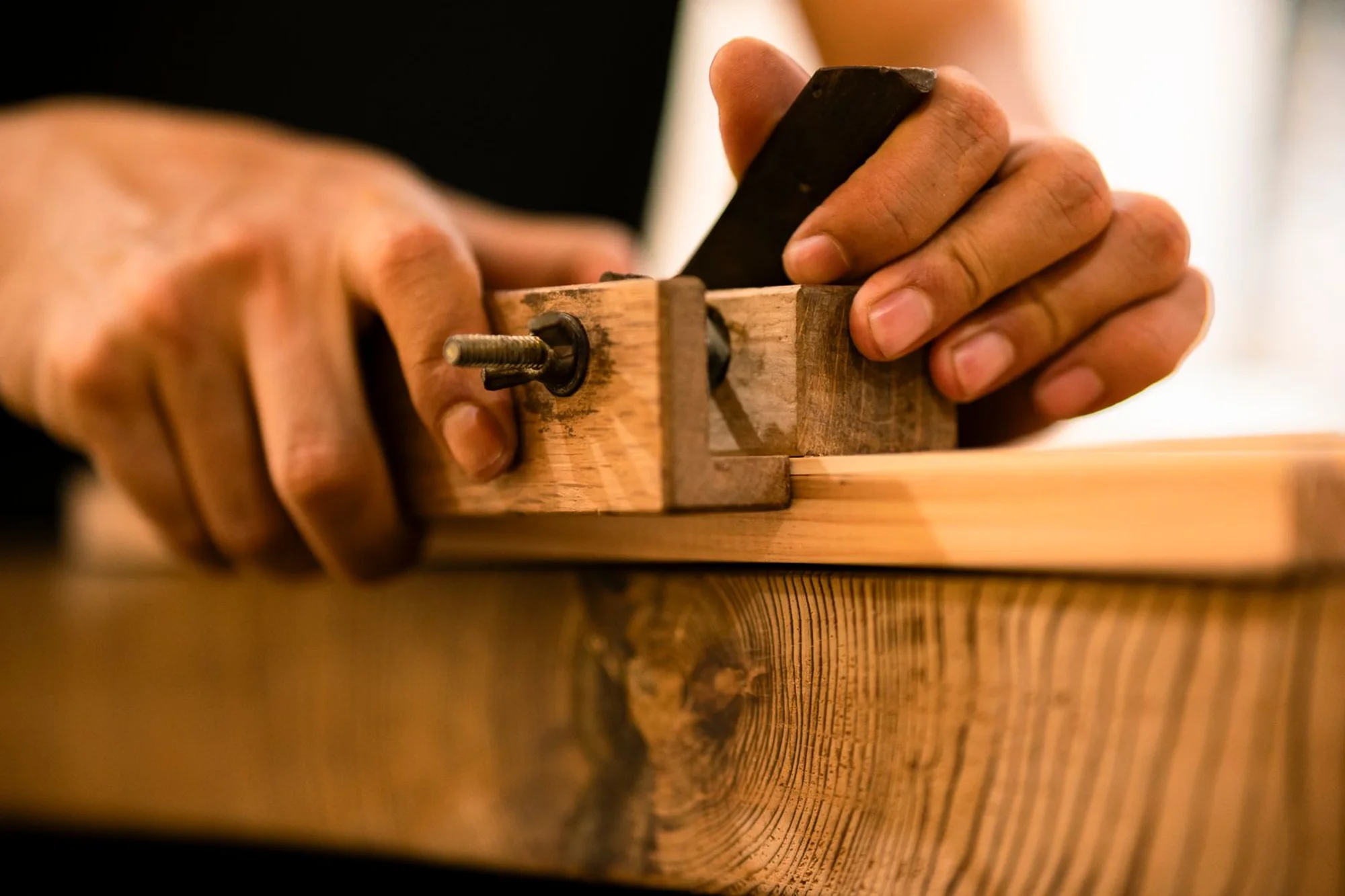 Close-up of the joiner's hands working the wood