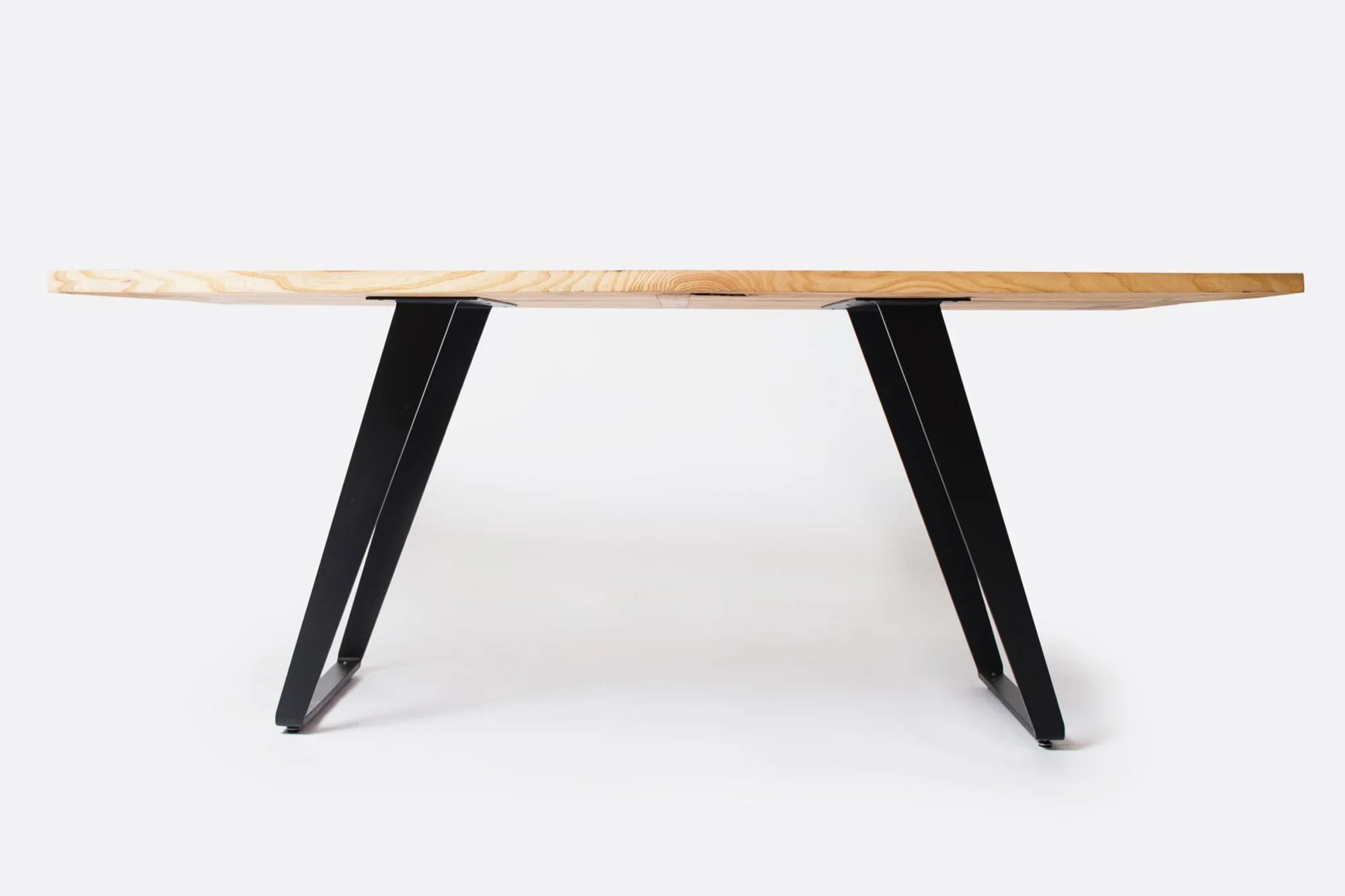 A bespoke solid-walnut table with steel legs