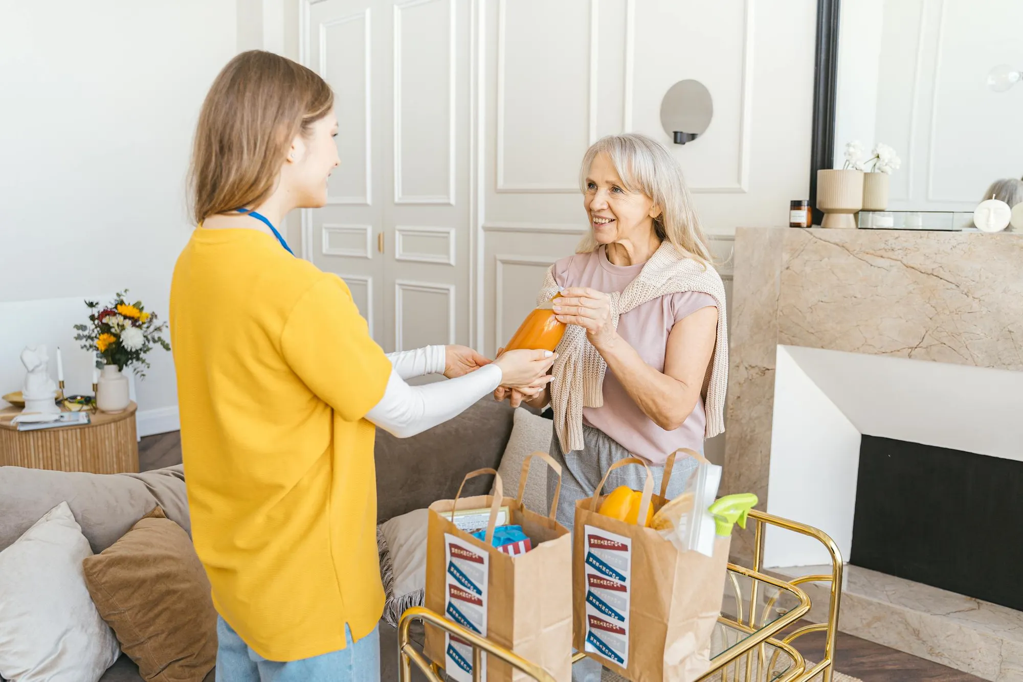 A caregiver lovingly assisting a smiling senior at home
