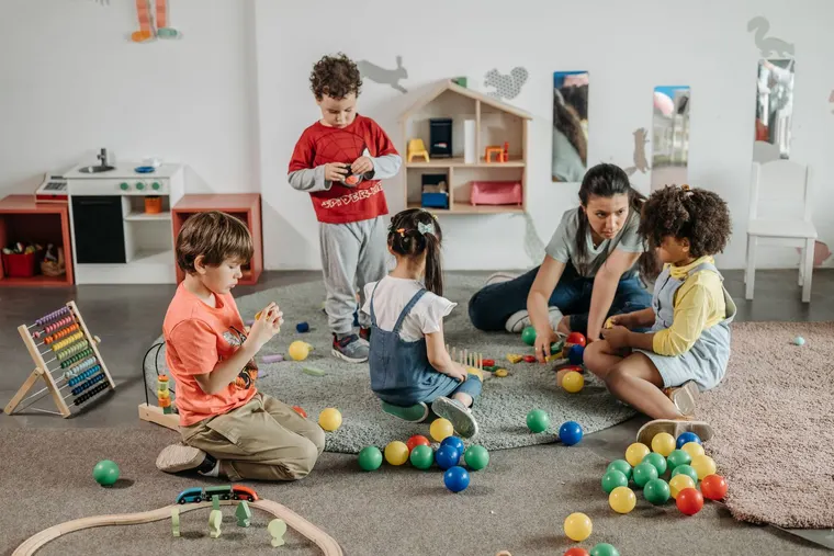 Children and an educator at the nursery