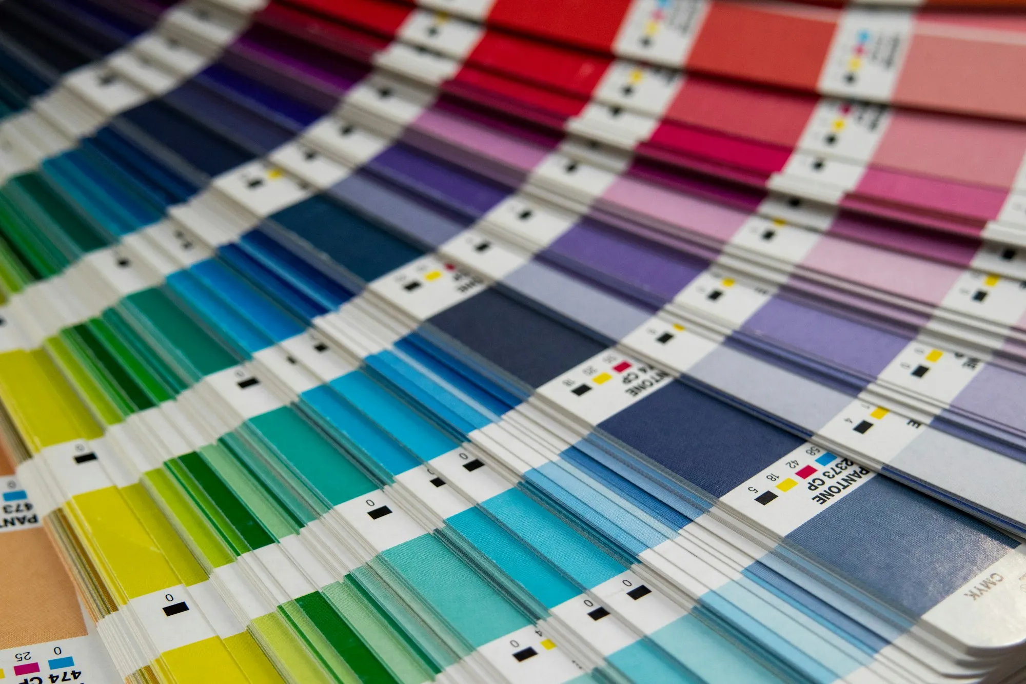 A fan deck of paint colour samples opened out