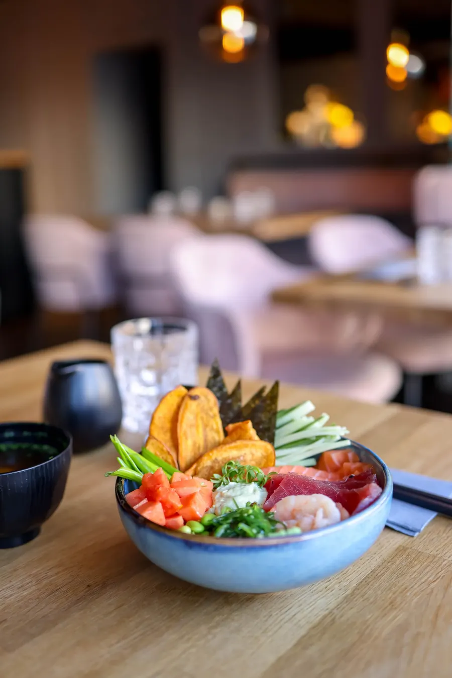 A poke bowl with salmon, avocado and edamame