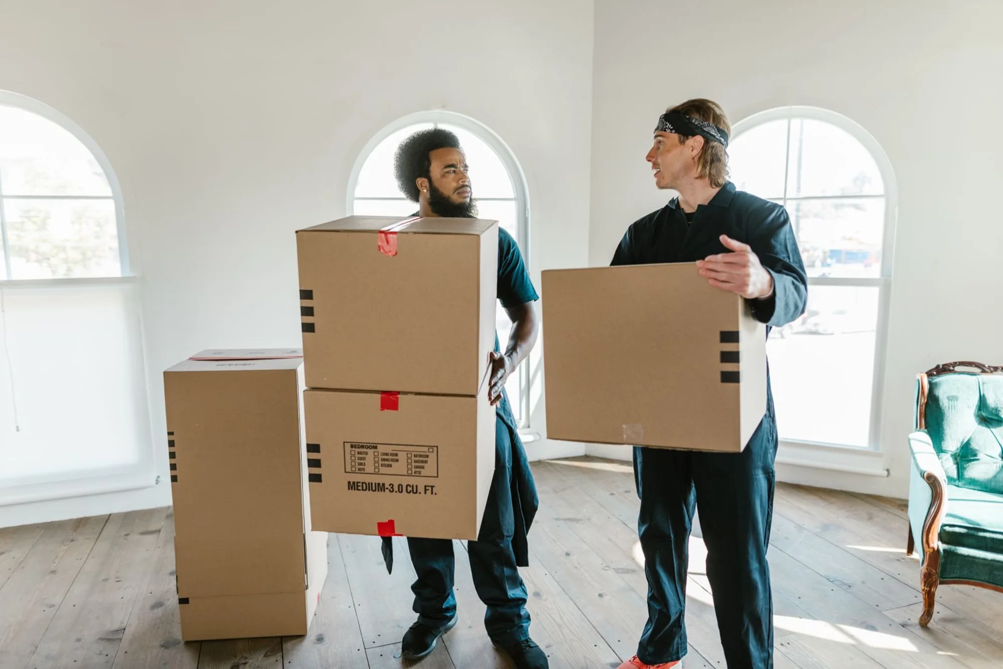 Professional movers loading a van